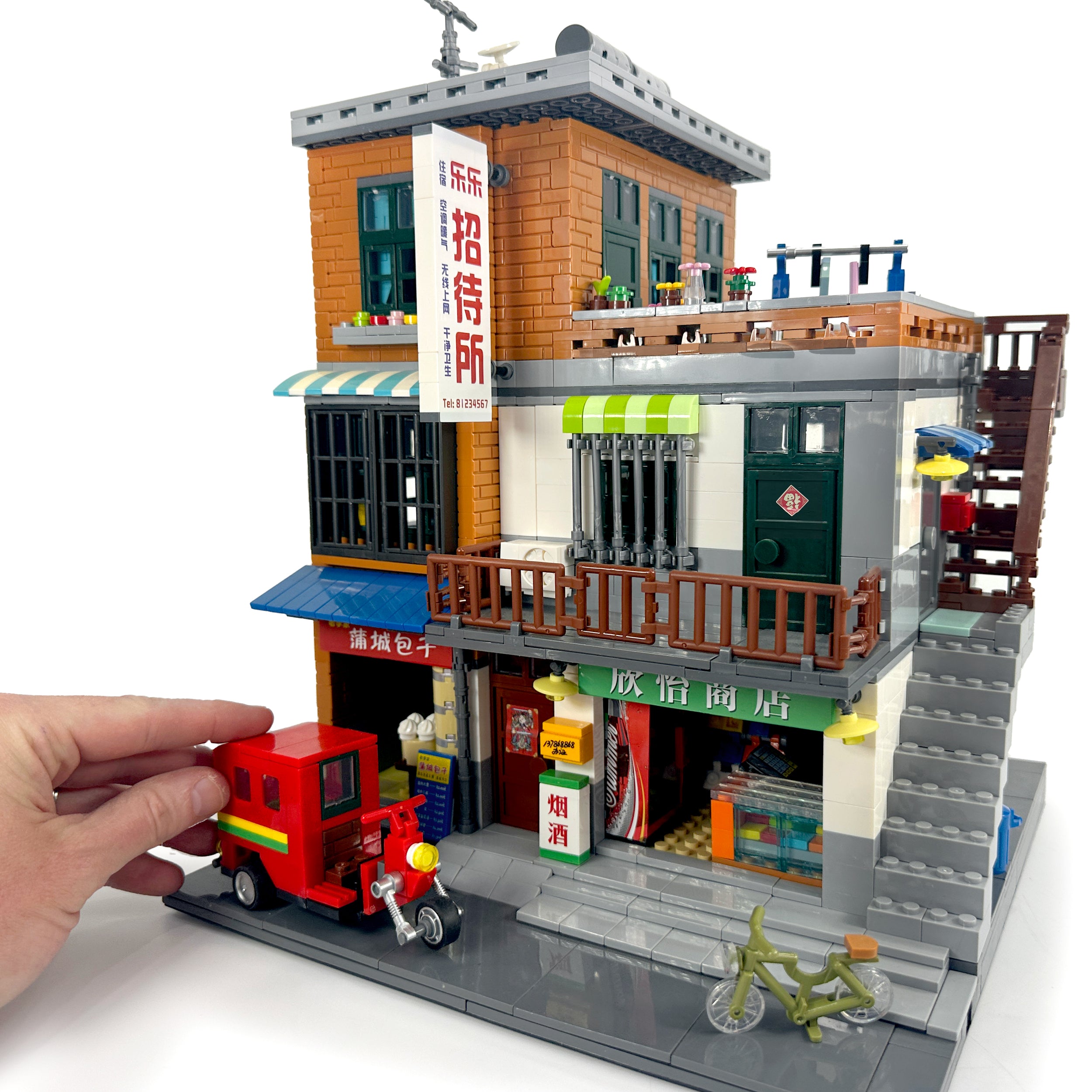 Front view with hand for scale demonstrating size of Urban Village City Series set