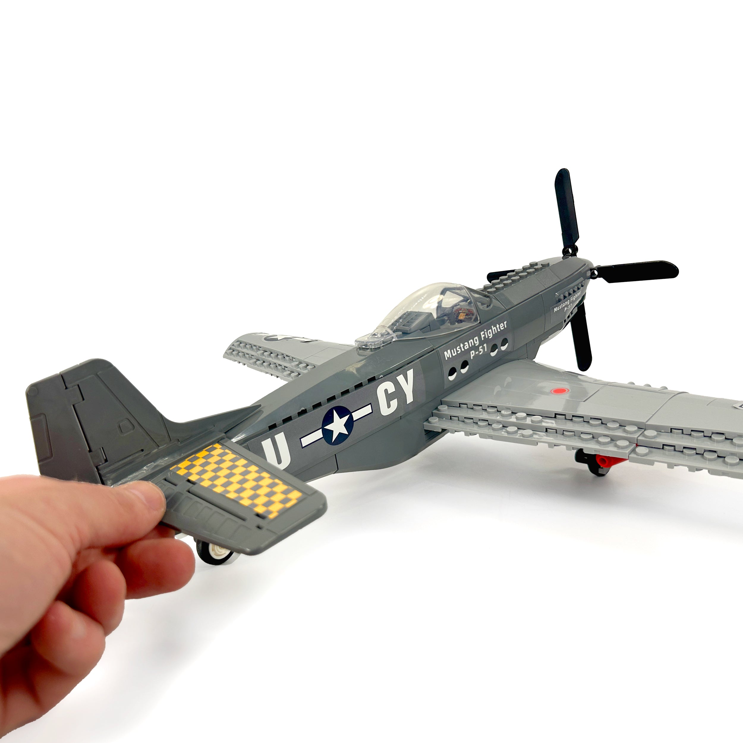 Full P-51 Mustang aircraft with hand for size perspective in aviation diorama