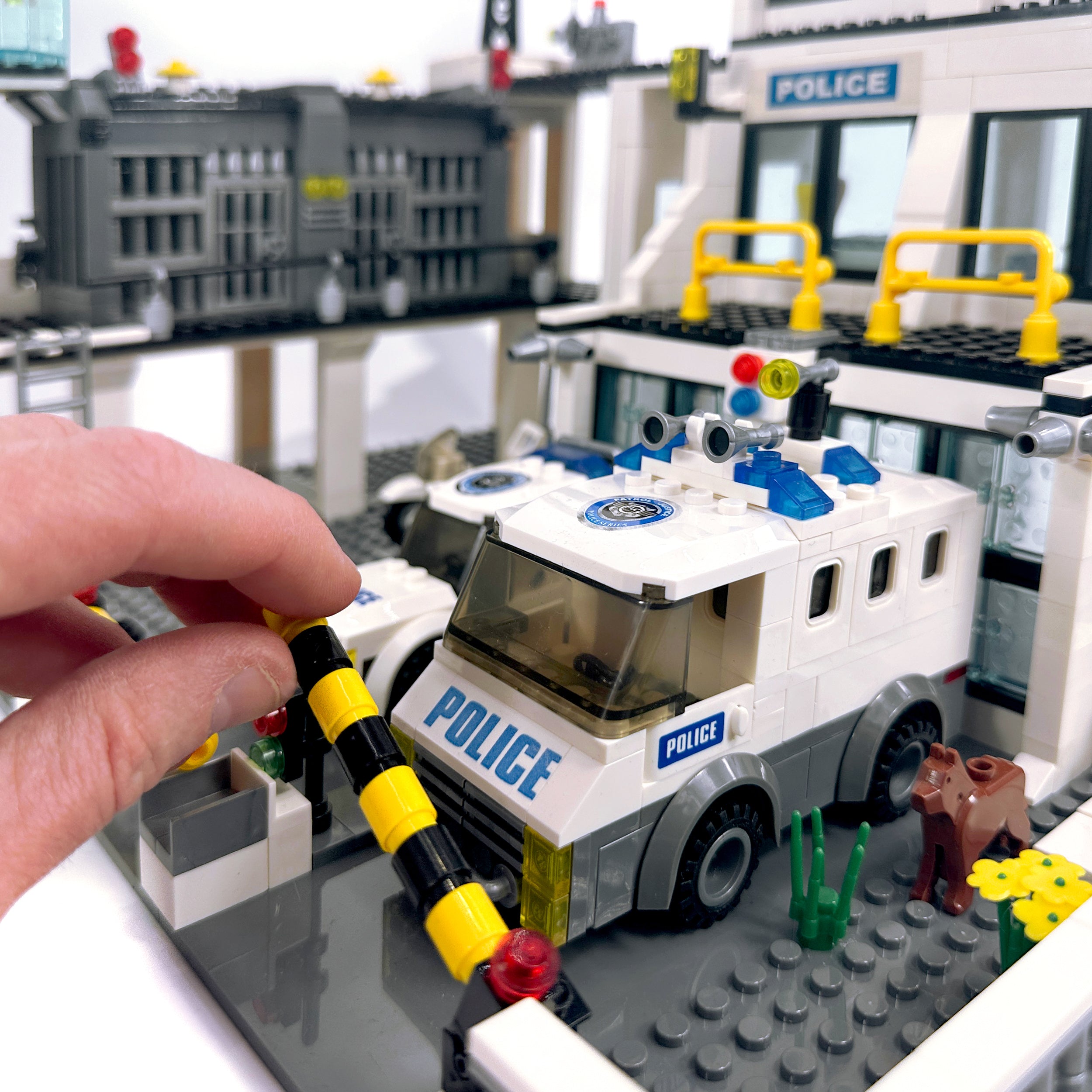 Police station modular set shown with hand for size scale reference