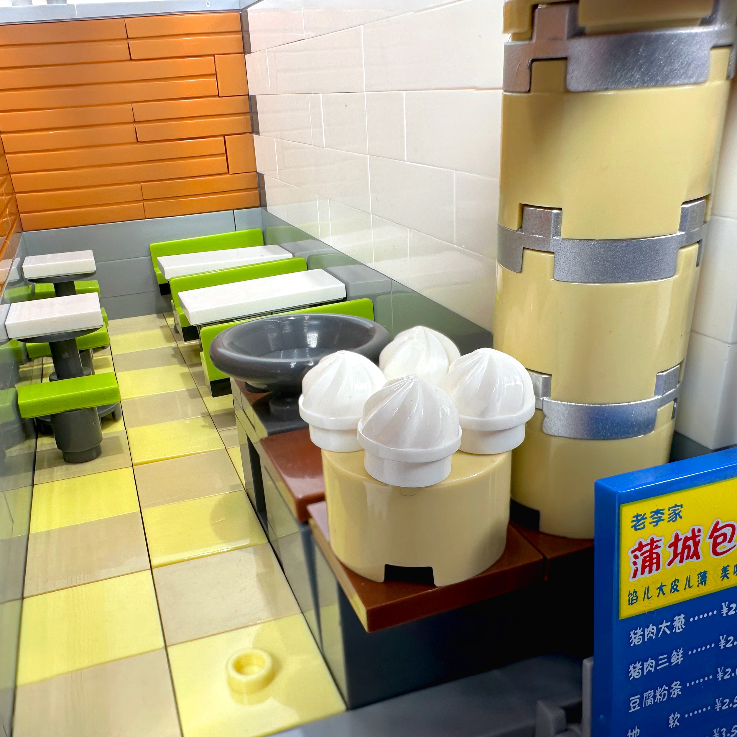 Interior view of first floor dumpling shop with menu board and seating area