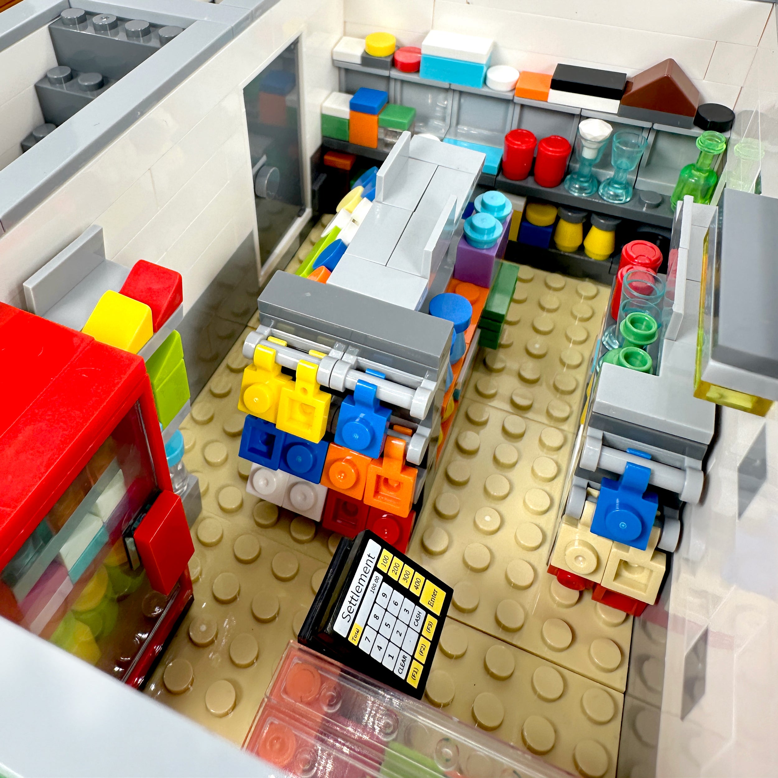 Interior view of convenience store with shelves, groceries, and checkout counter