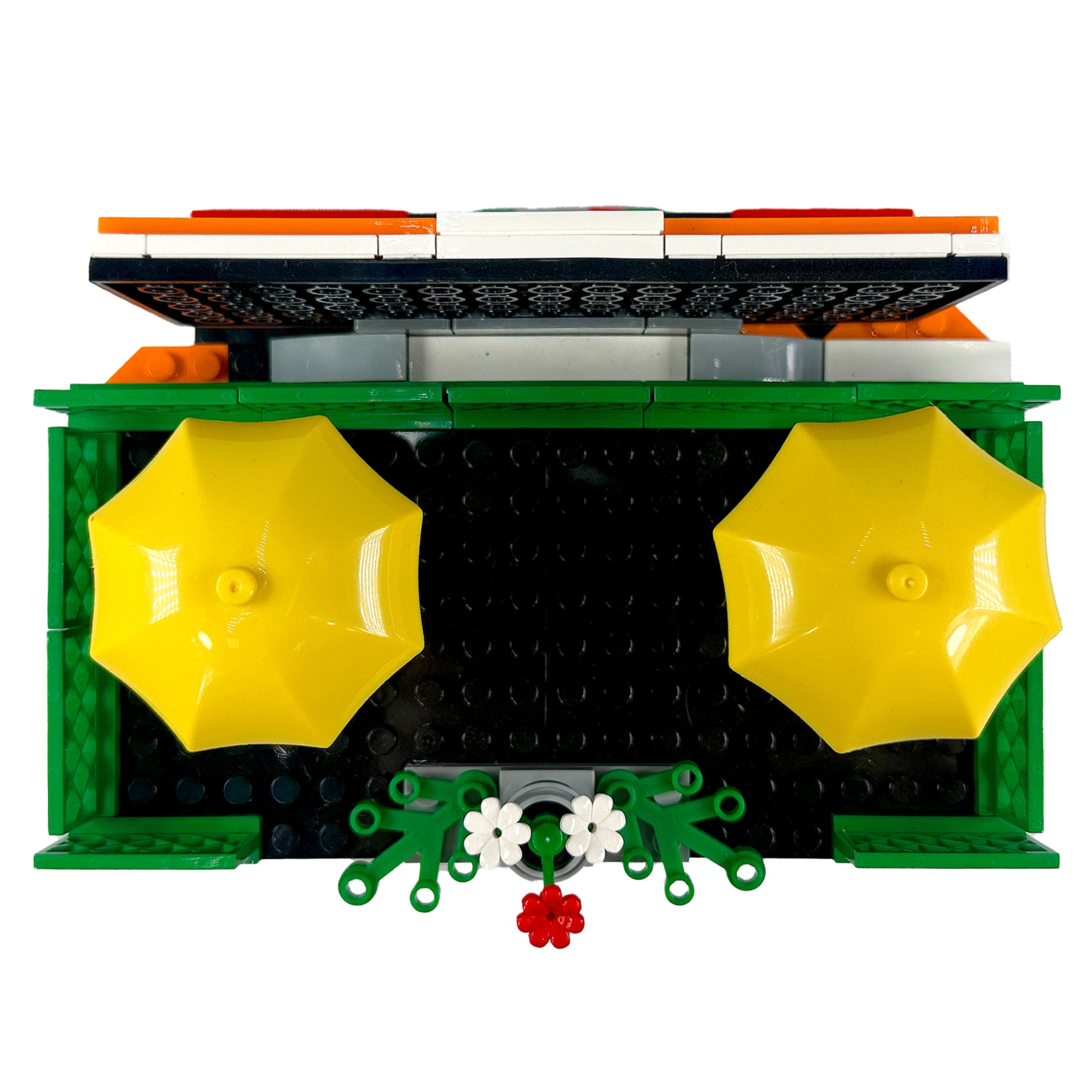 Top-down view of rooftop patio scene with tables, umbrellas, and flower details