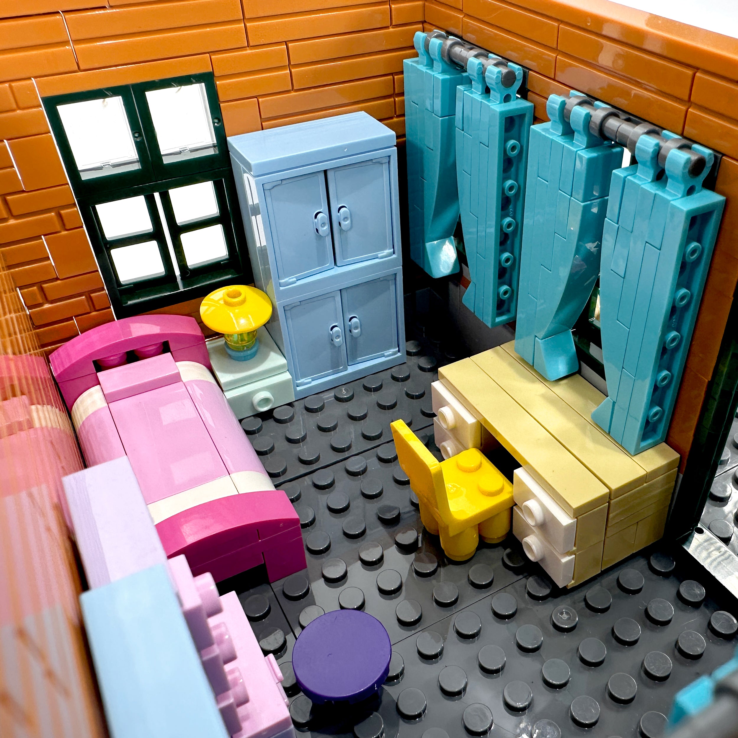 Interior view of second-floor lounge area with TV, desk, and window