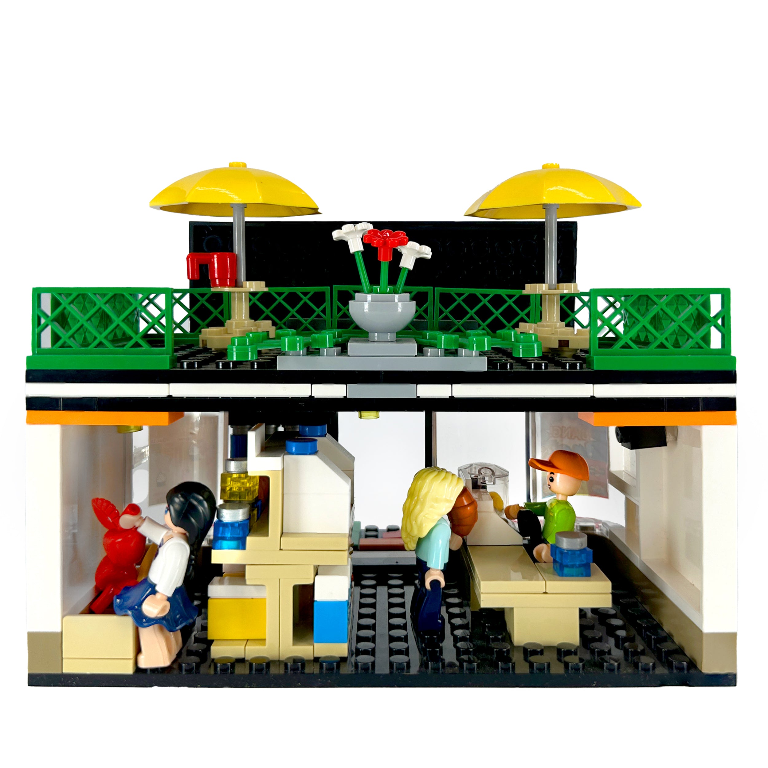 Back view of city mini-mart model with open rear showing shelves, accessories, and figures