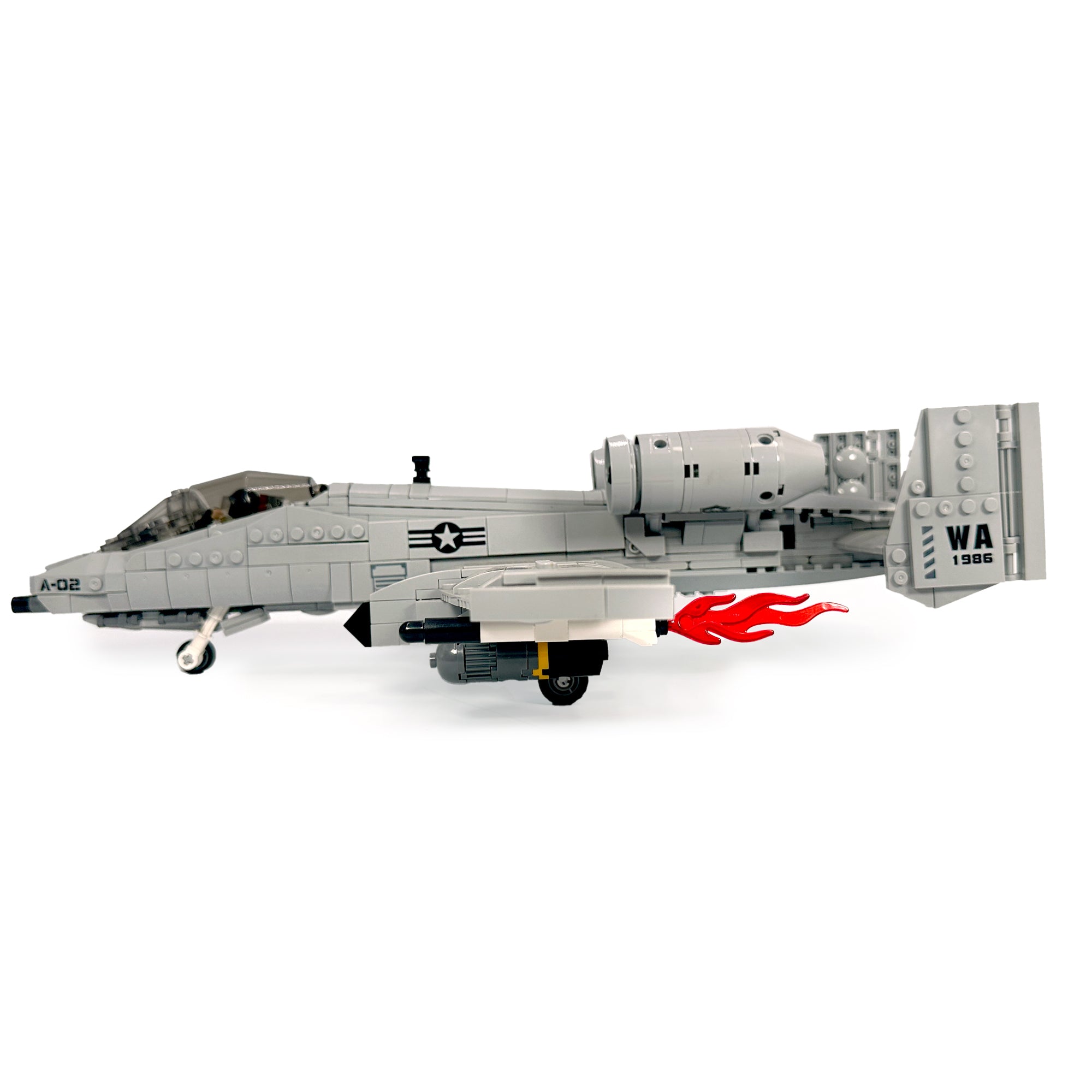 Left-side profile of assembled ground-attack jet model with flame detail at engine exhaust. 